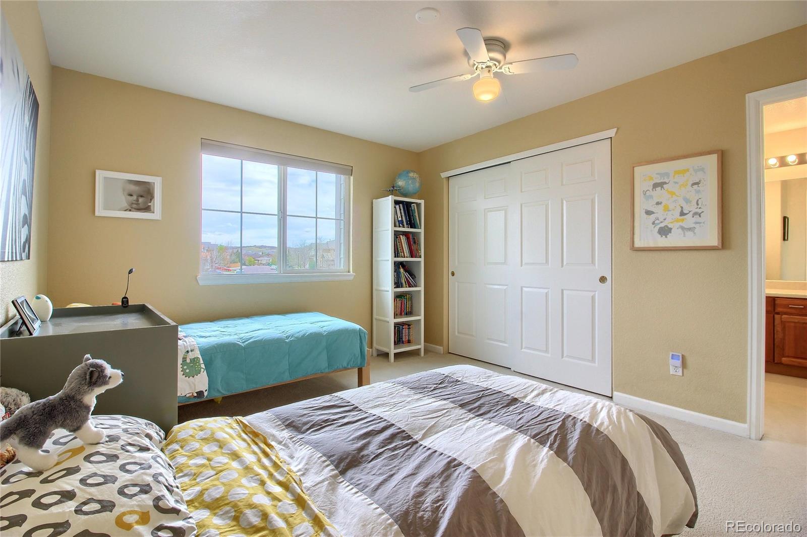 10677 Wynspire Road Highlands Ranch, CO 80130 - Photo 31 of 40 a bedroom with a bed and a window