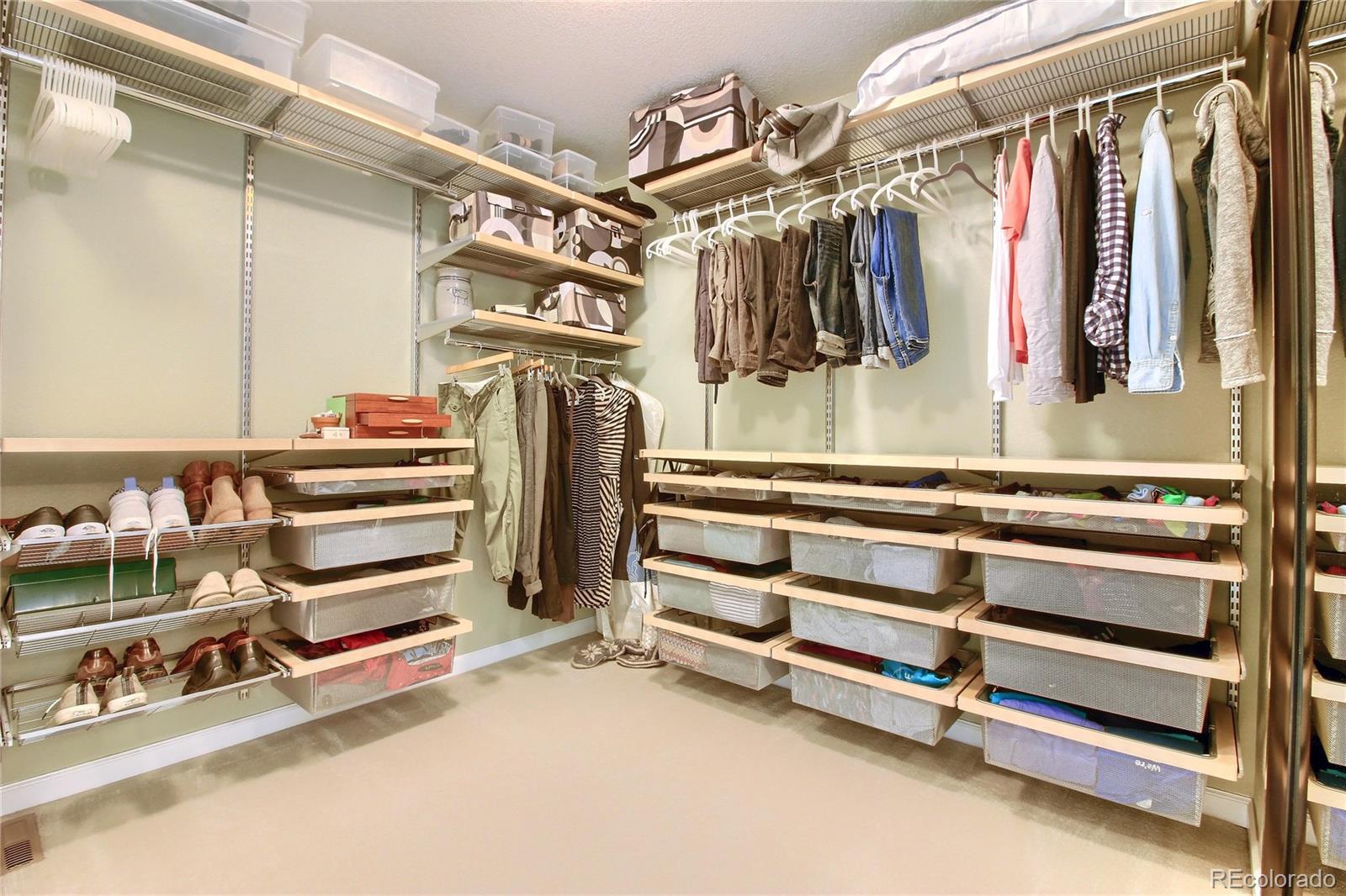 10677 Wynspire Road Highlands Ranch, CO 80130 - Photo 34 of 40 a view of walk in closet with clothes and shoes