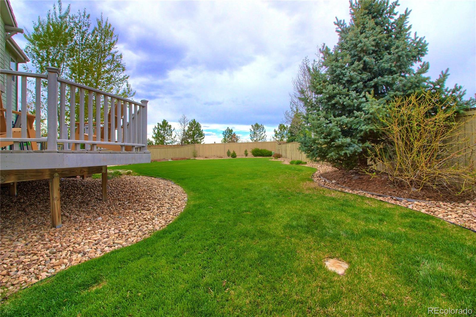 10677 Wynspire Road Highlands Ranch, CO 80130 - Photo 37 of 40 a view of a backyard with a garden