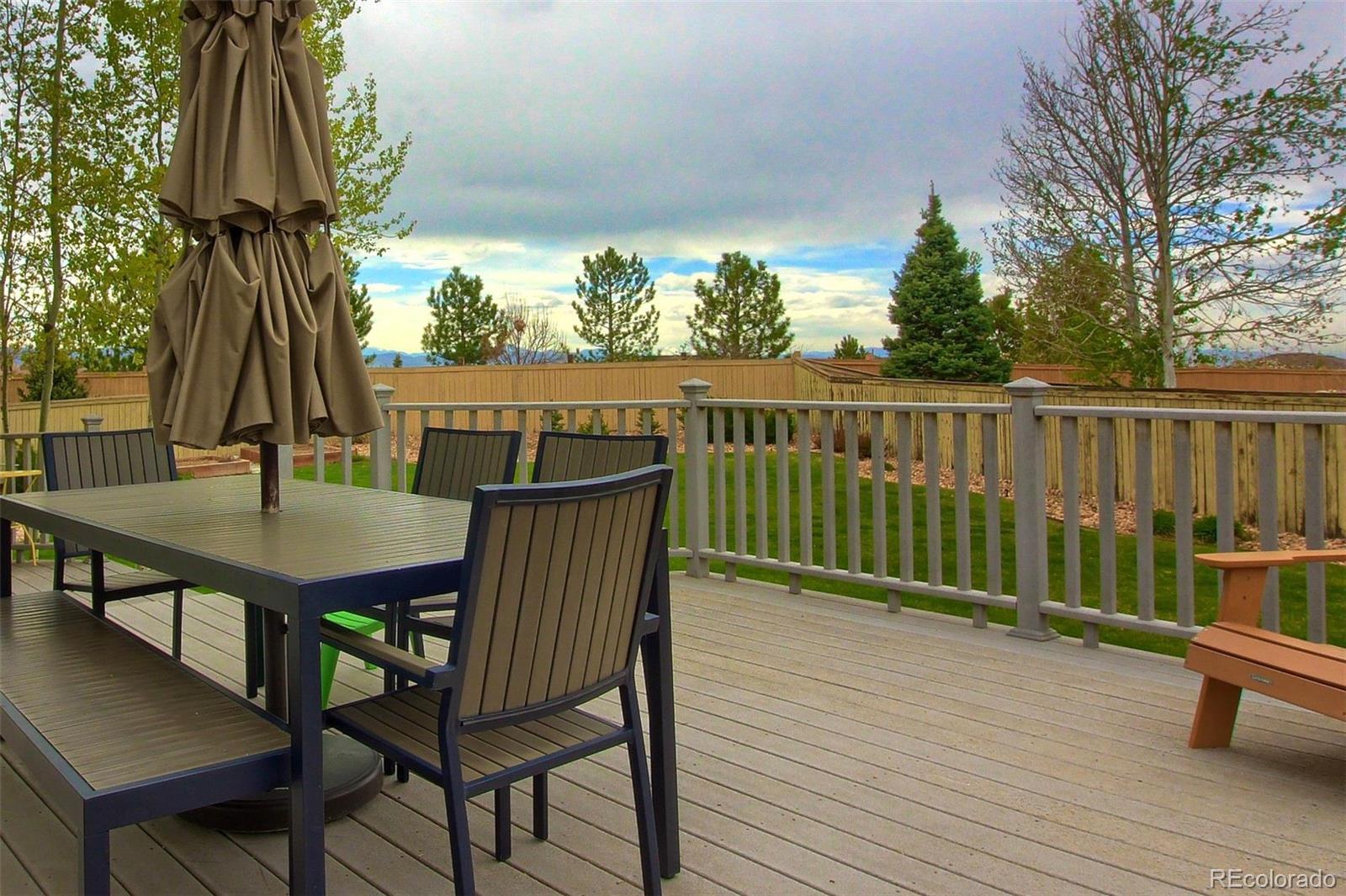 10677 Wynspire Road Highlands Ranch, CO 80130 - Photo 38 of 40 a view of balcony with wooden floor and outdoor seating