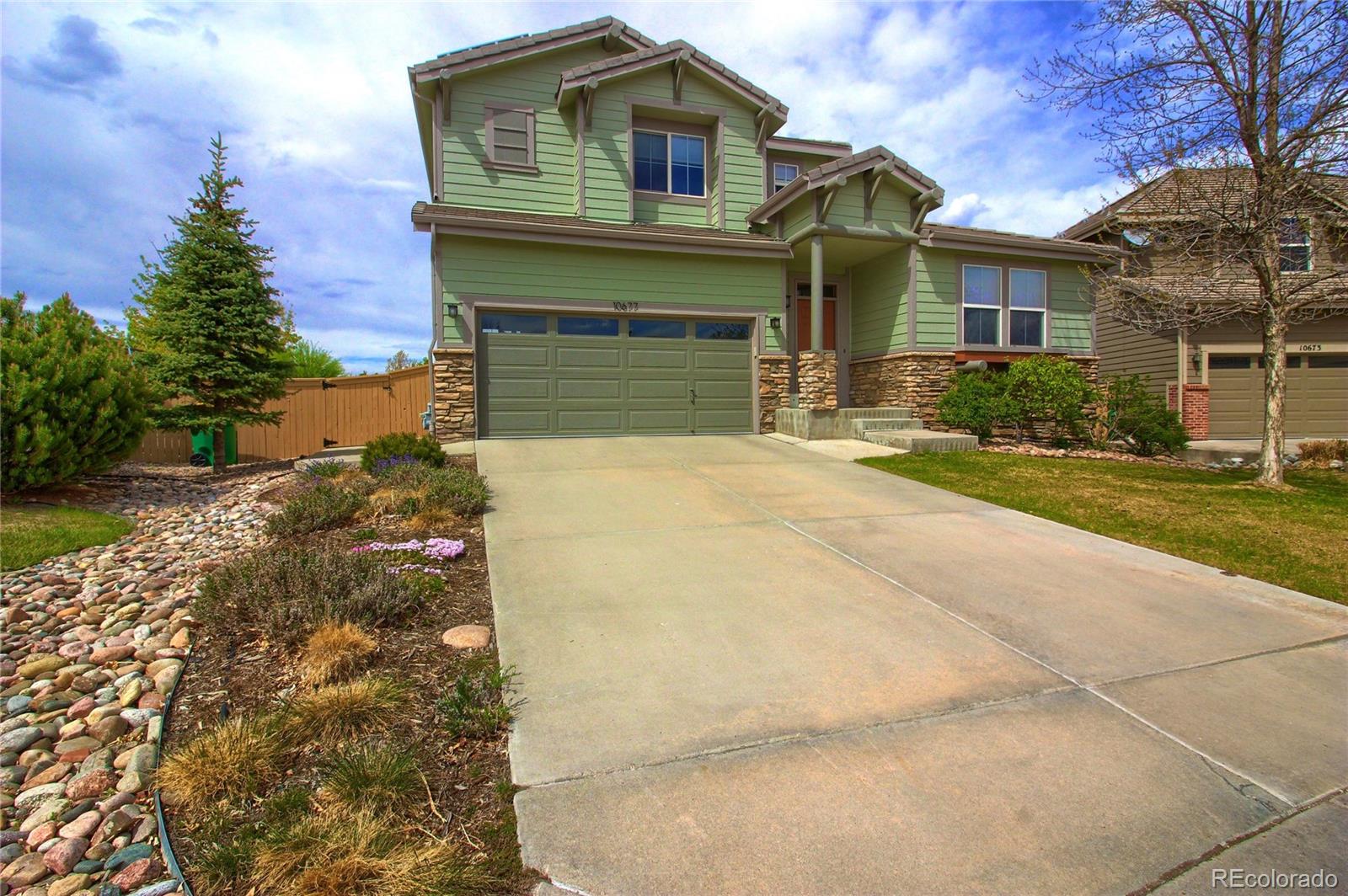 10677 Wynspire Road Highlands Ranch, CO 80130 - Photo 40 of 40 a front view of a house with a yard and garage
