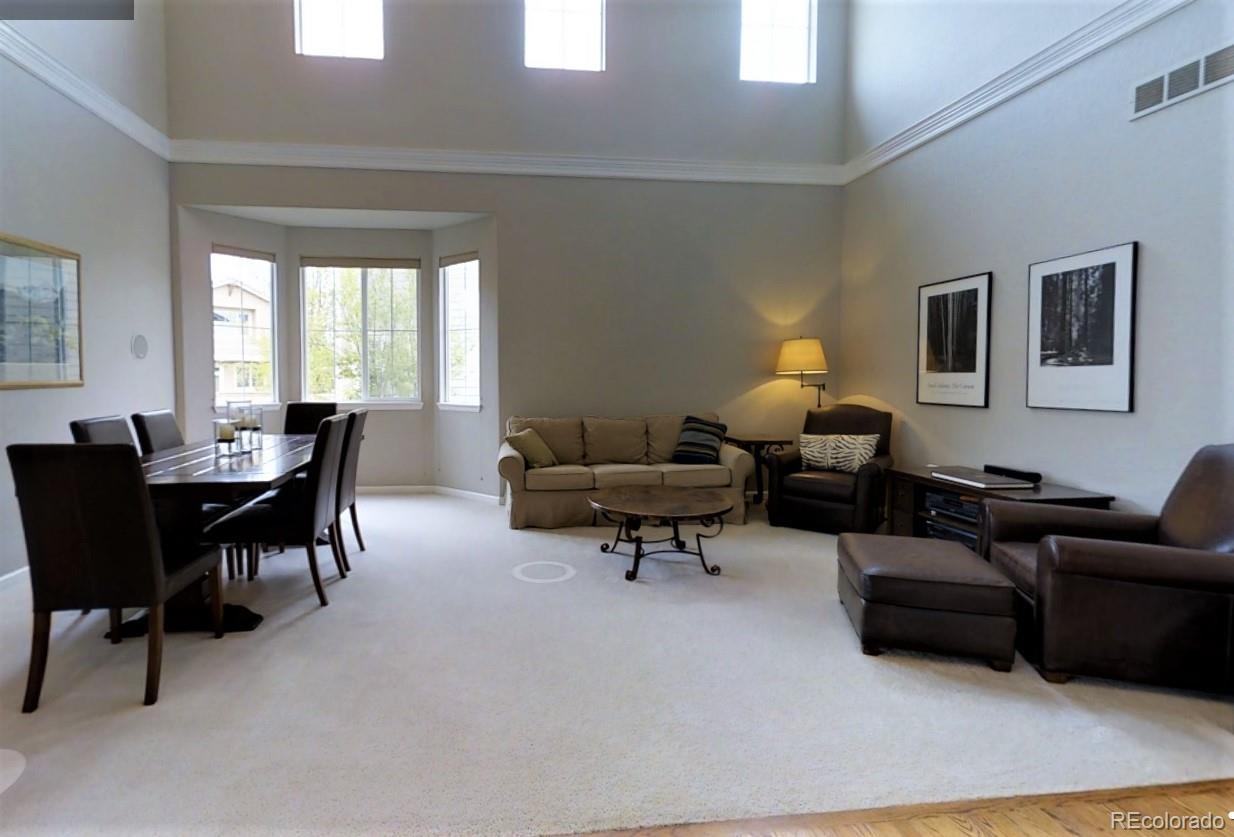 10677 Wynspire Road Highlands Ranch, CO 80130 - Photo 5 of 40 a living room with furniture a lamp and a large window
