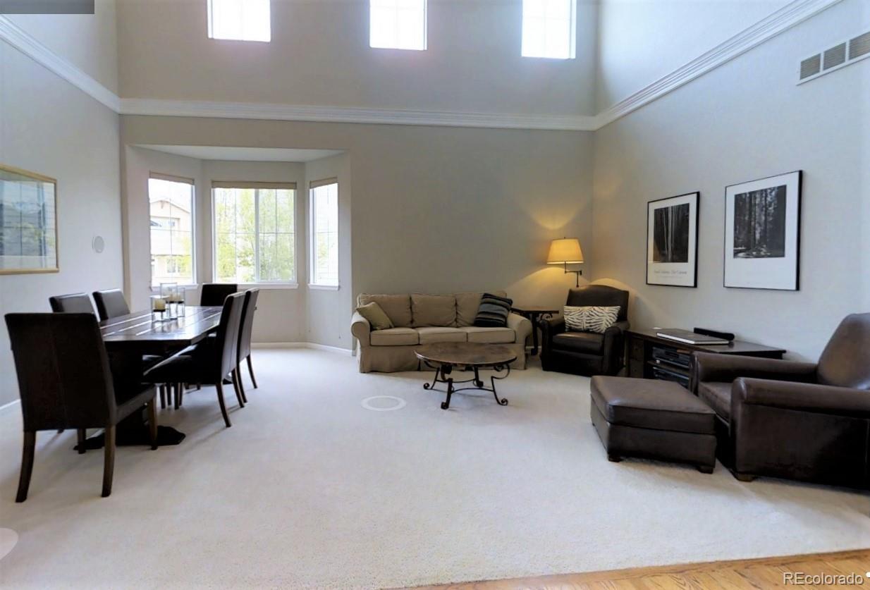10677 Wynspire Road Highlands Ranch, CO 80130 - Photo 6 of 40 a living room with furniture and a large window