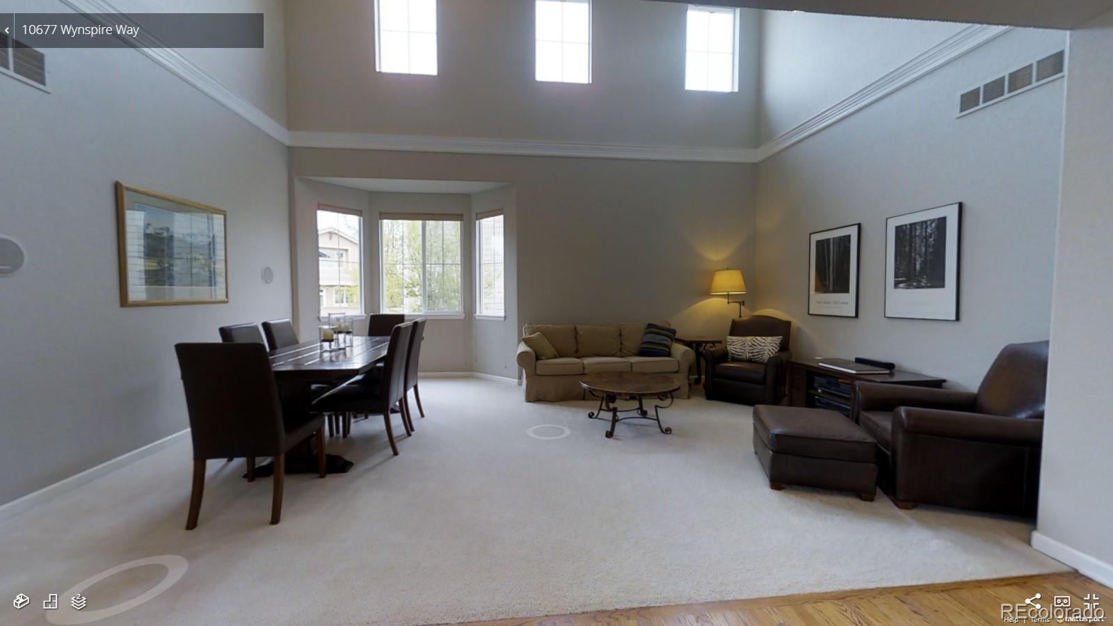 10677 Wynspire Road Highlands Ranch, CO 80130 - Photo 7 of 40 a living room with furniture and a wooden floor