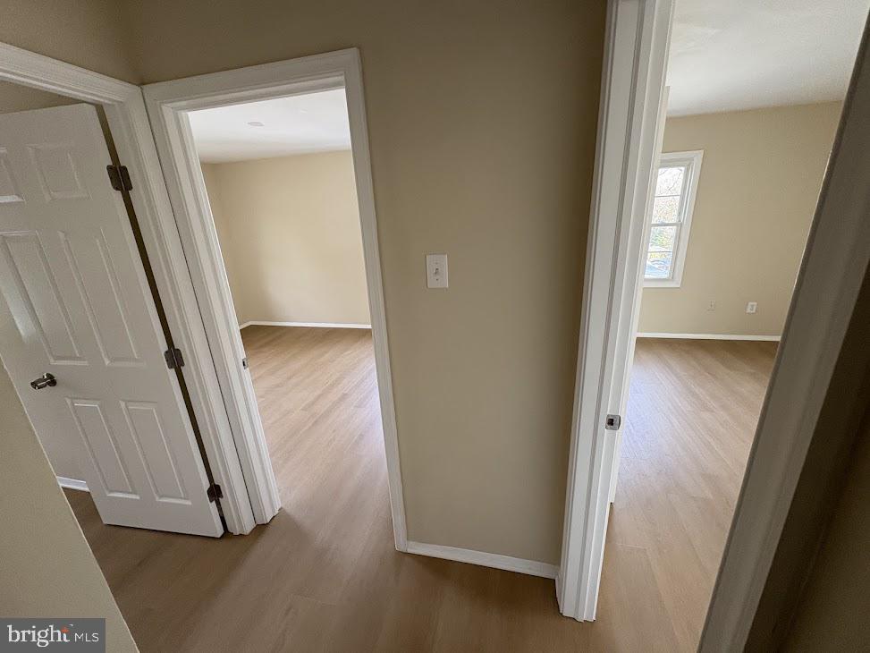 7907 Chalice Road Severn, MD 21144 - Photo 11 of 34 an entryway with wooden floor and a mirror