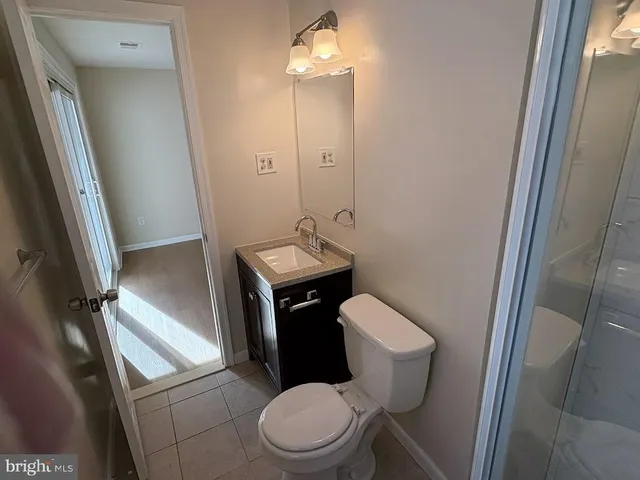 a white toilet sitting next to a bathroom sink