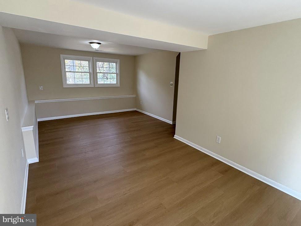 7907 Chalice Road Severn, MD 21144 - Photo 21 of 34 an empty room with wooden floor and windows