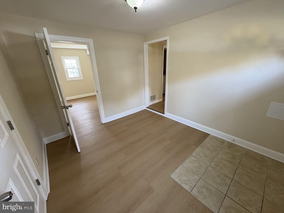 7907 Chalice Road Severn, MD 21144 - Photo 22 of 34 an empty room with windows and entrance