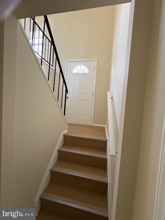 7907 Chalice Road Severn, MD 21144 - Photo 26 of 34 a view of staircase with wooden floor and white walls
