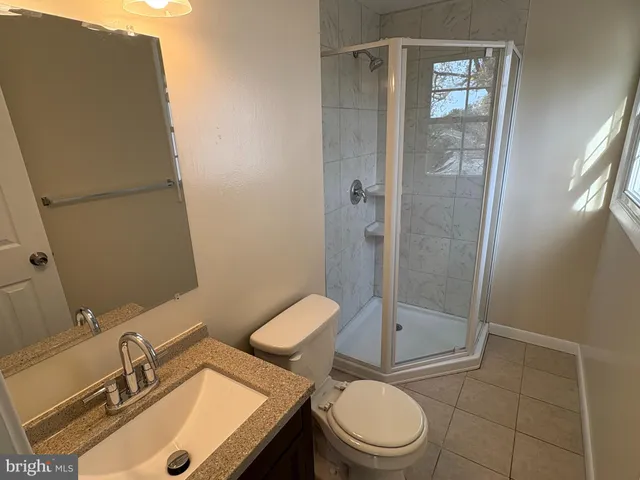 a bathroom with a toilet a sink and shower