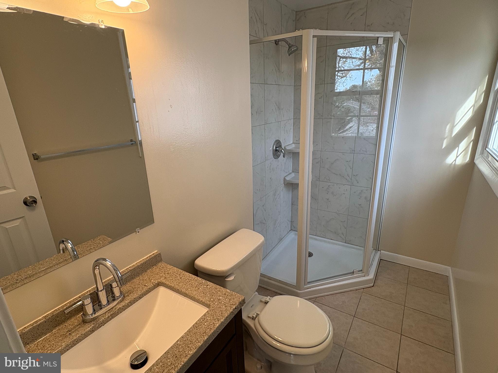 7907 Chalice Road Severn, MD 21144 - Photo 28 of 34 a bathroom with a toilet a sink and shower