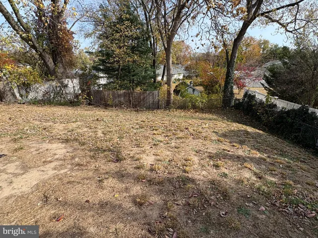 a backyard of a house with large trees