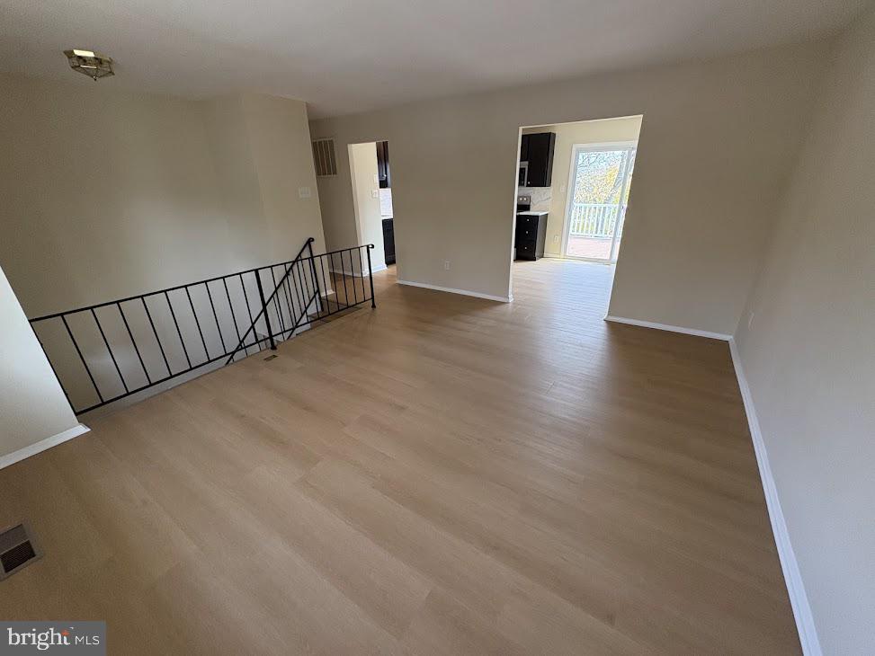7907 Chalice Road Severn, MD 21144 - Photo 6 of 34 a view of a hallway with wooden floor