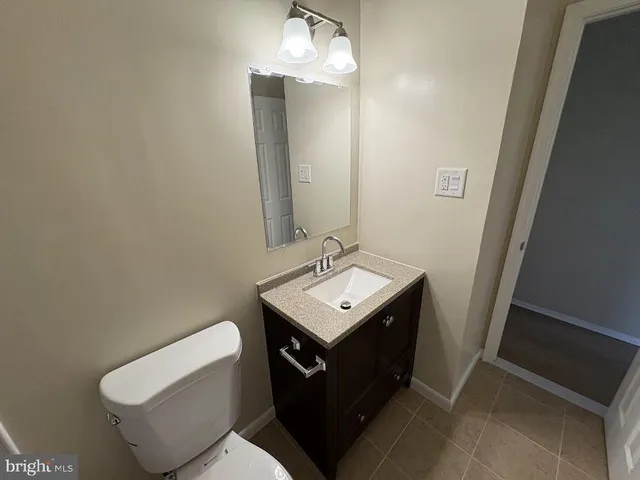 a bathroom with a sink toilet and mirror