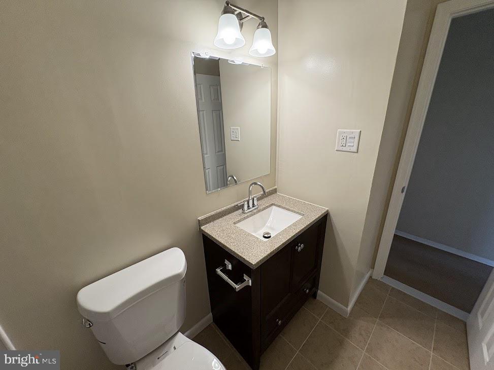 7907 Chalice Road Severn, MD 21144 - Photo 10 of 34 a bathroom with a sink toilet and mirror