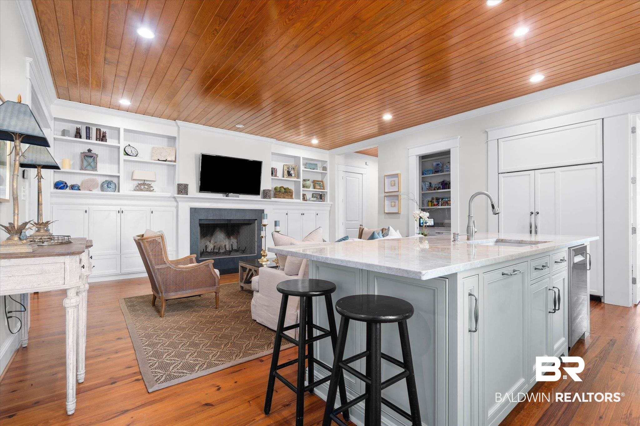 3813 Austill Lane Mobile, AL 36608 - Photo 8 of 37 Open-concept living space featuring wood-finish flooring, a wood plank ceiling with recessed lighting, and a kitchen island with a light-toned countertop and built-in sink