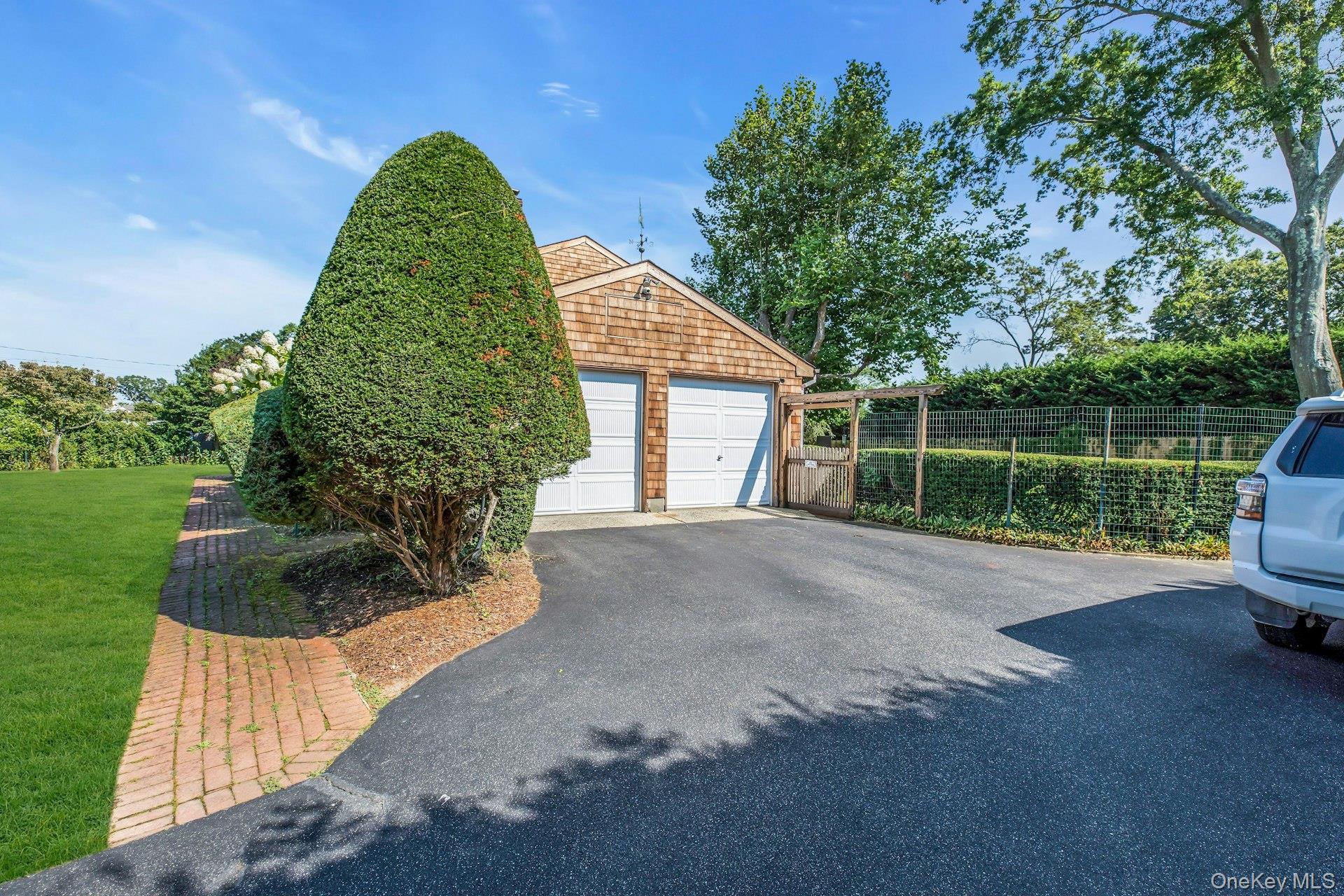 8 Adelphi Street Islip, NY 11751 - Photo 27 of 38 Ample Parking. Long Driveway with Turn-around Area. Interior Access from Garage to House. Fire Island Style Sliding Gate to Yard and Rear Entry.
