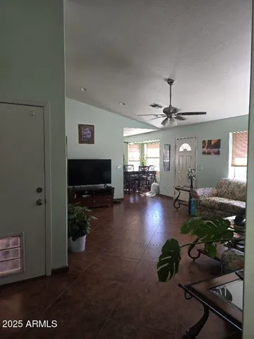 a living room with furniture and a flat screen tv