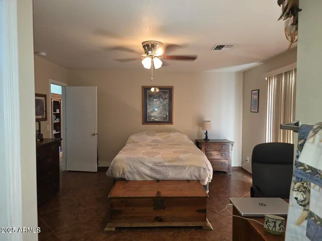 a bedroom with bed and window