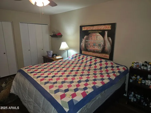 a bedroom with a bed and a wall painting