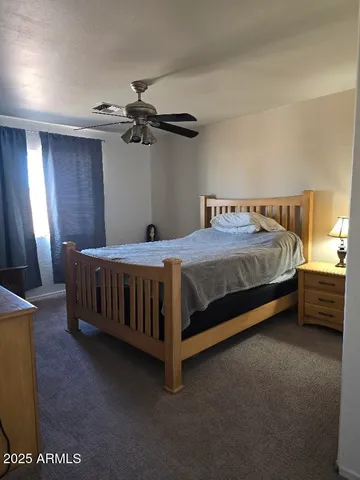 a bedroom with a bed dresser and a window