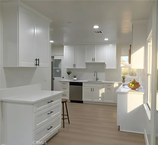a kitchen with a sink and cabinets