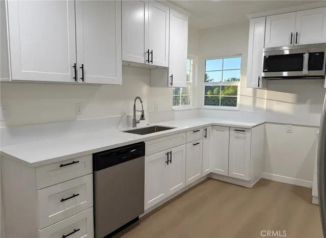 a spacious bedroom with a bed and a chandelier
