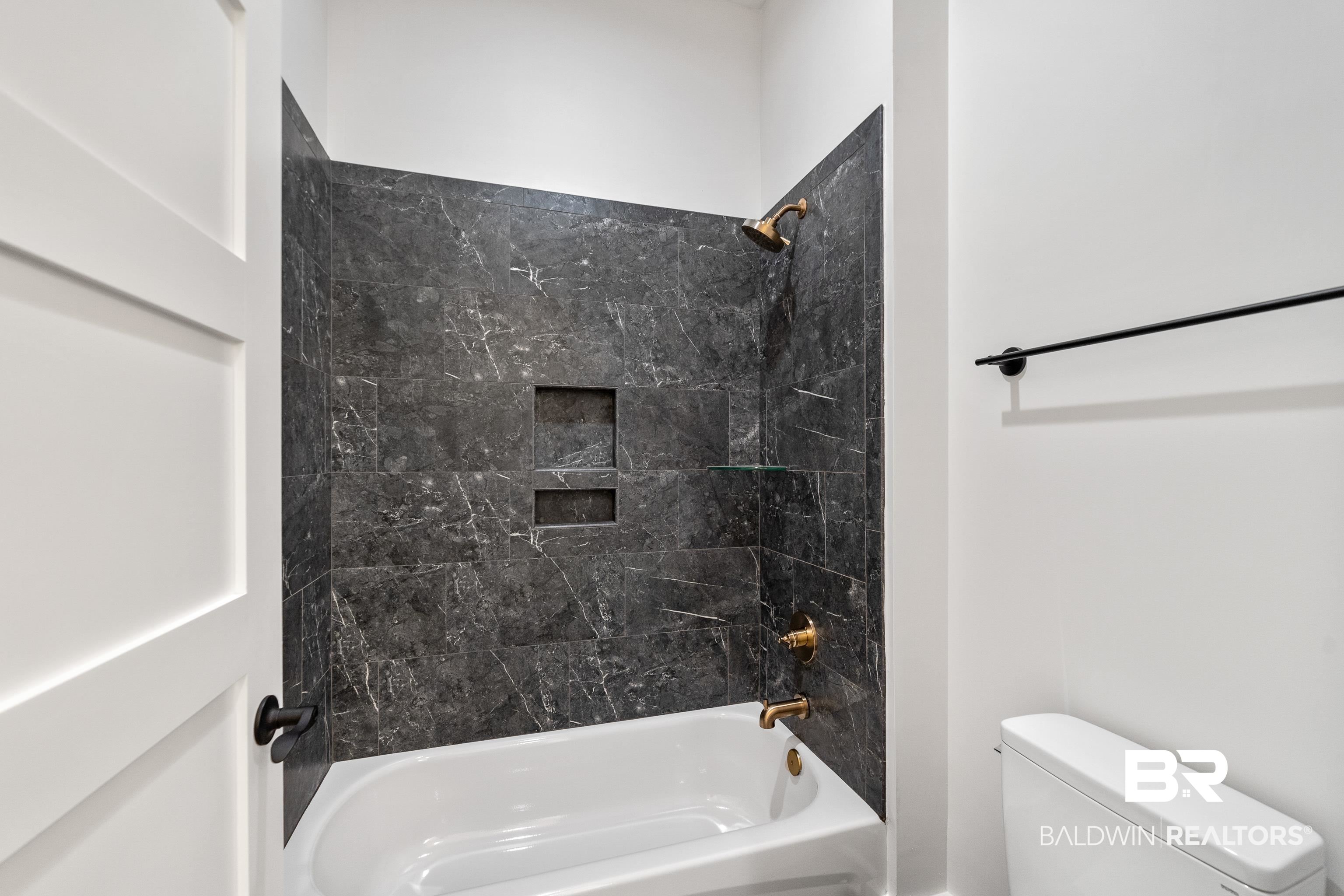 12453 County Road 1 Fairhope, AL 36532 - Photo 24 of 33 Bathroom featuring tiled shower / bath combo and toilet