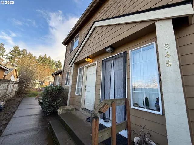 a view of balcony with two chairs and a window