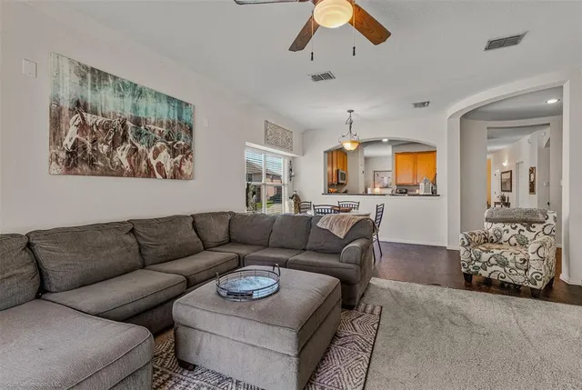 a living room with furniture and painting on the wall