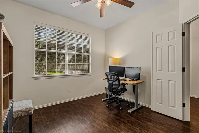 a view of a workspace with furniture and a window