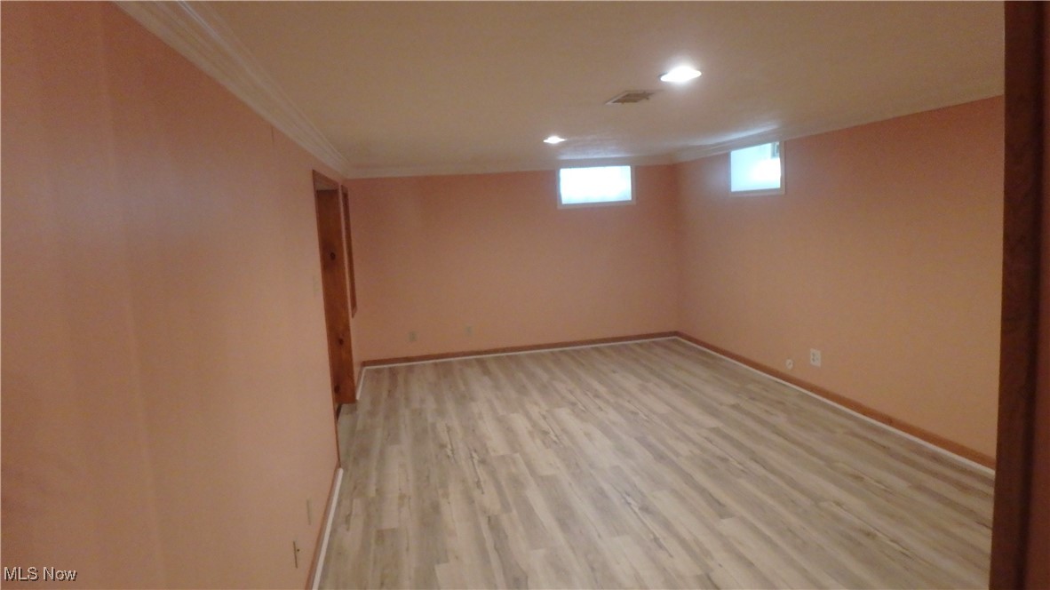 2901 Dentzler Road Parma, OH 44134 - Photo 20 of 25 Basement with light wood finished floors, ornamental molding, and recessed lighting
