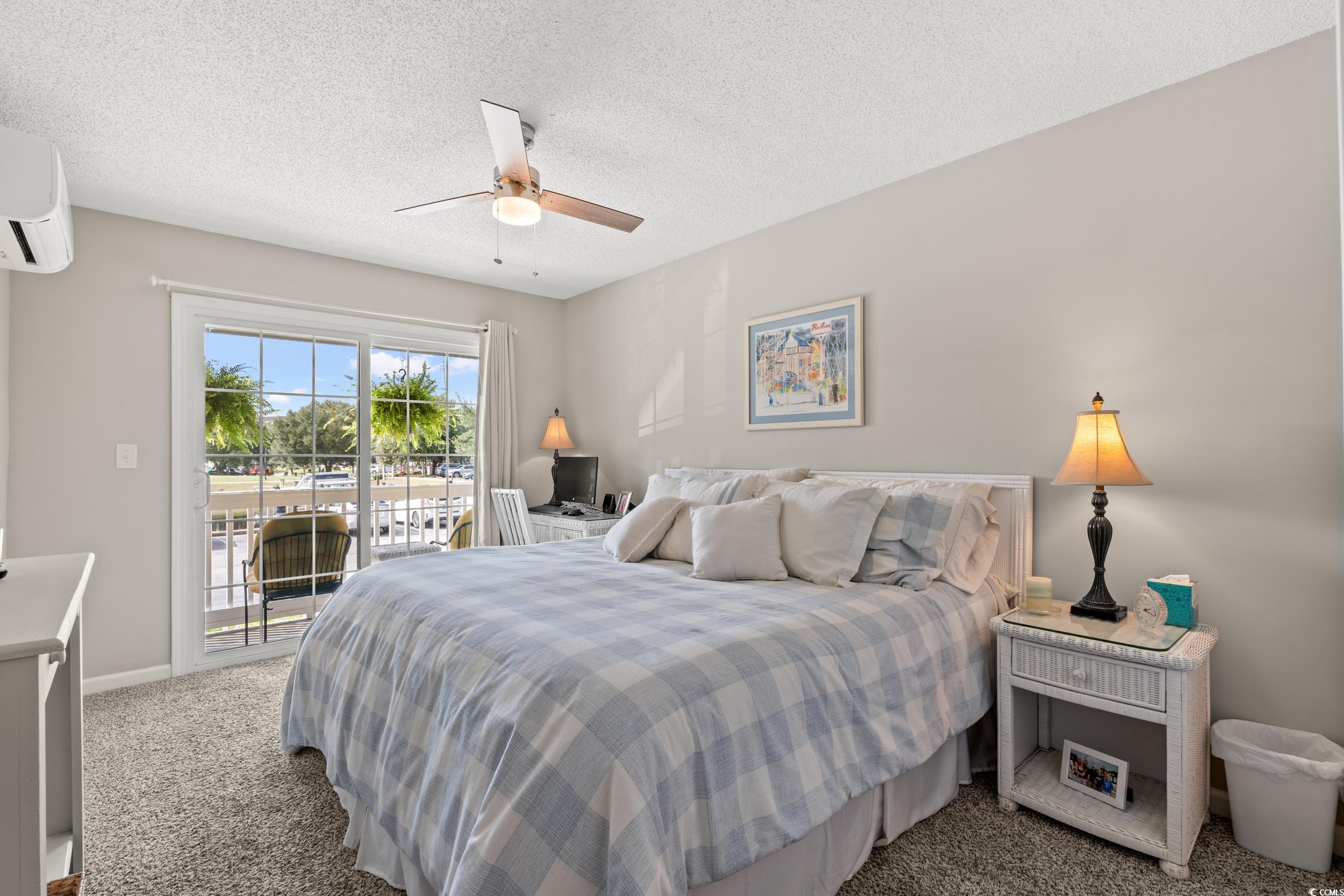 14 Laurel Street, Unit 14 Conway, SC 29526 - Photo 20 of 40 Carpeted bedroom with a textured ceiling, access to outside, ceiling fan, and a wall mounted AC