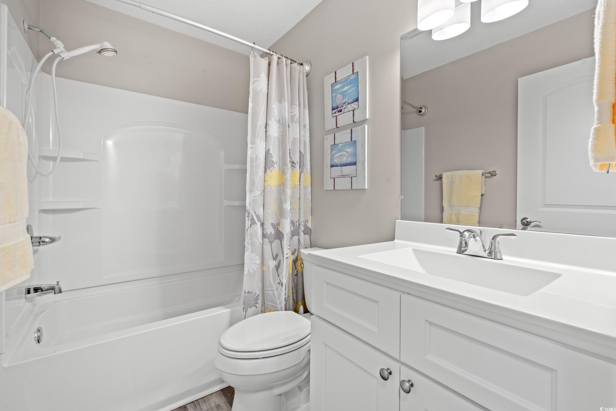 14 Laurel Street, Unit 14 Conway, SC 29526 - Photo 22 of 40 Bathroom with shower / bathtub combination with curtain and vanity