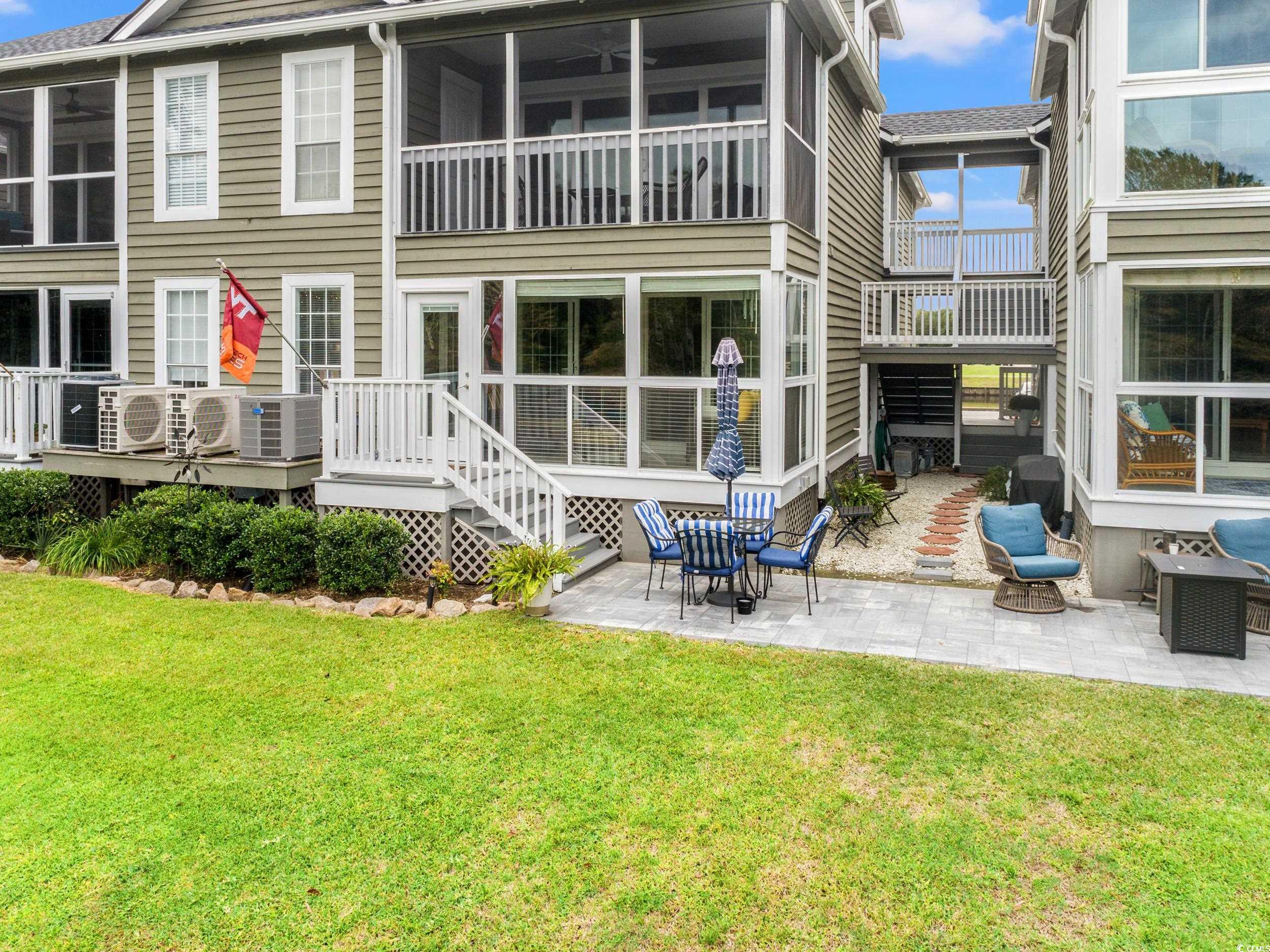 14 Laurel Street, Unit 14 Conway, SC 29526 - Photo 24 of 40 Rear view of property featuring a patio area, a lawn, and a sunroom