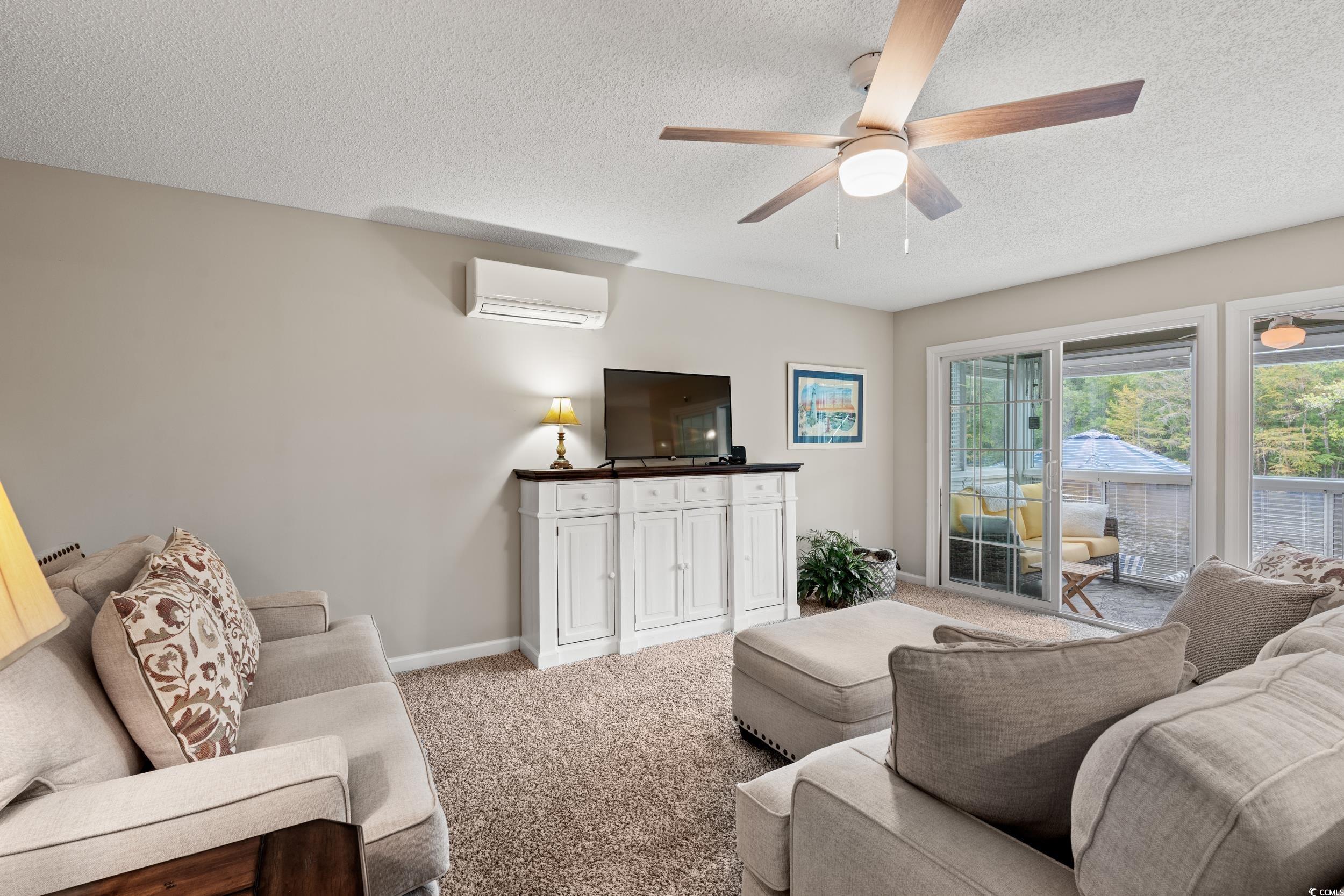 14 Laurel Street, Unit 14 Conway, SC 29526 - Photo 5 of 40 Carpeted living area with a textured ceiling, a wall unit AC, and ceiling fan