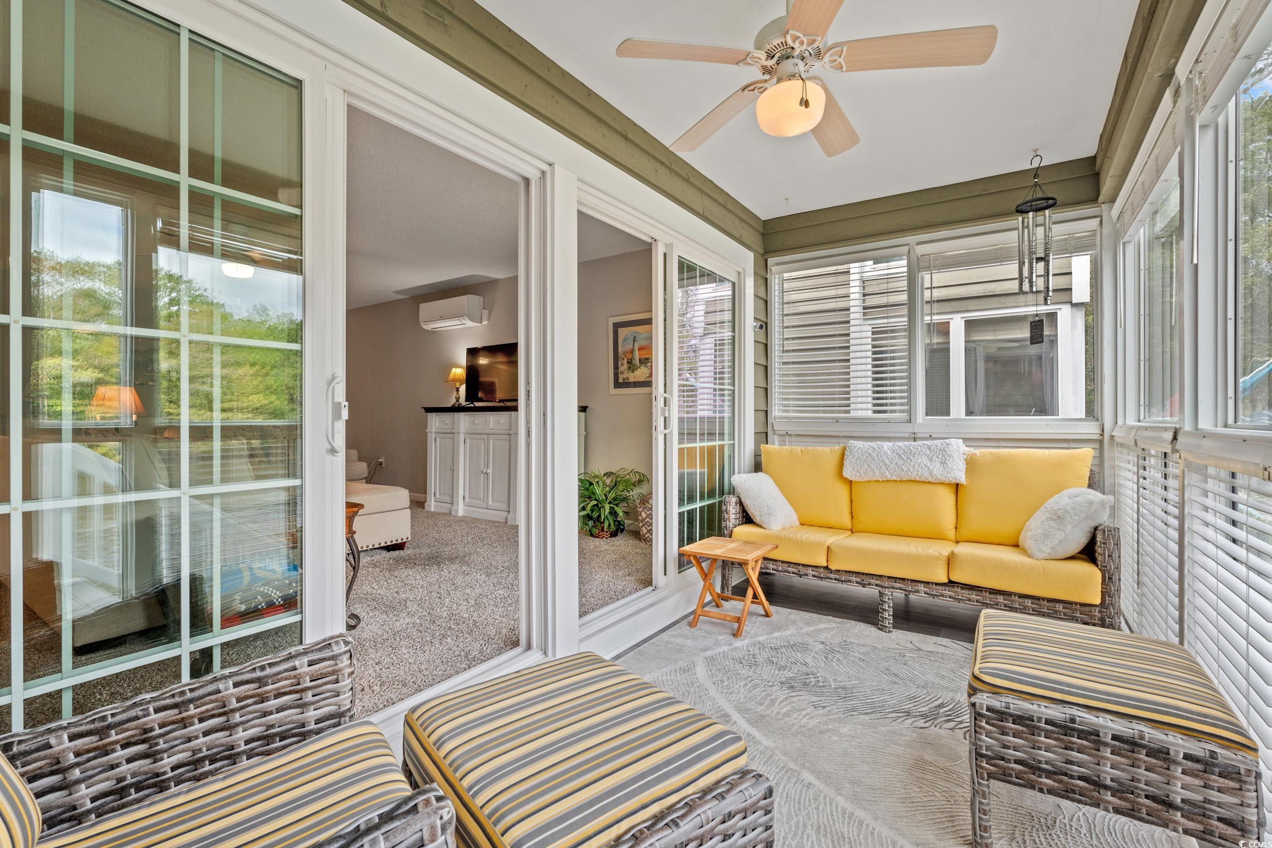 14 Laurel Street, Unit 14 Conway, SC 29526 - Photo 7 of 40 Sunroom / solarium featuring outdoor lounge area, a ceiling fan, carpet floors, and a wall unit AC