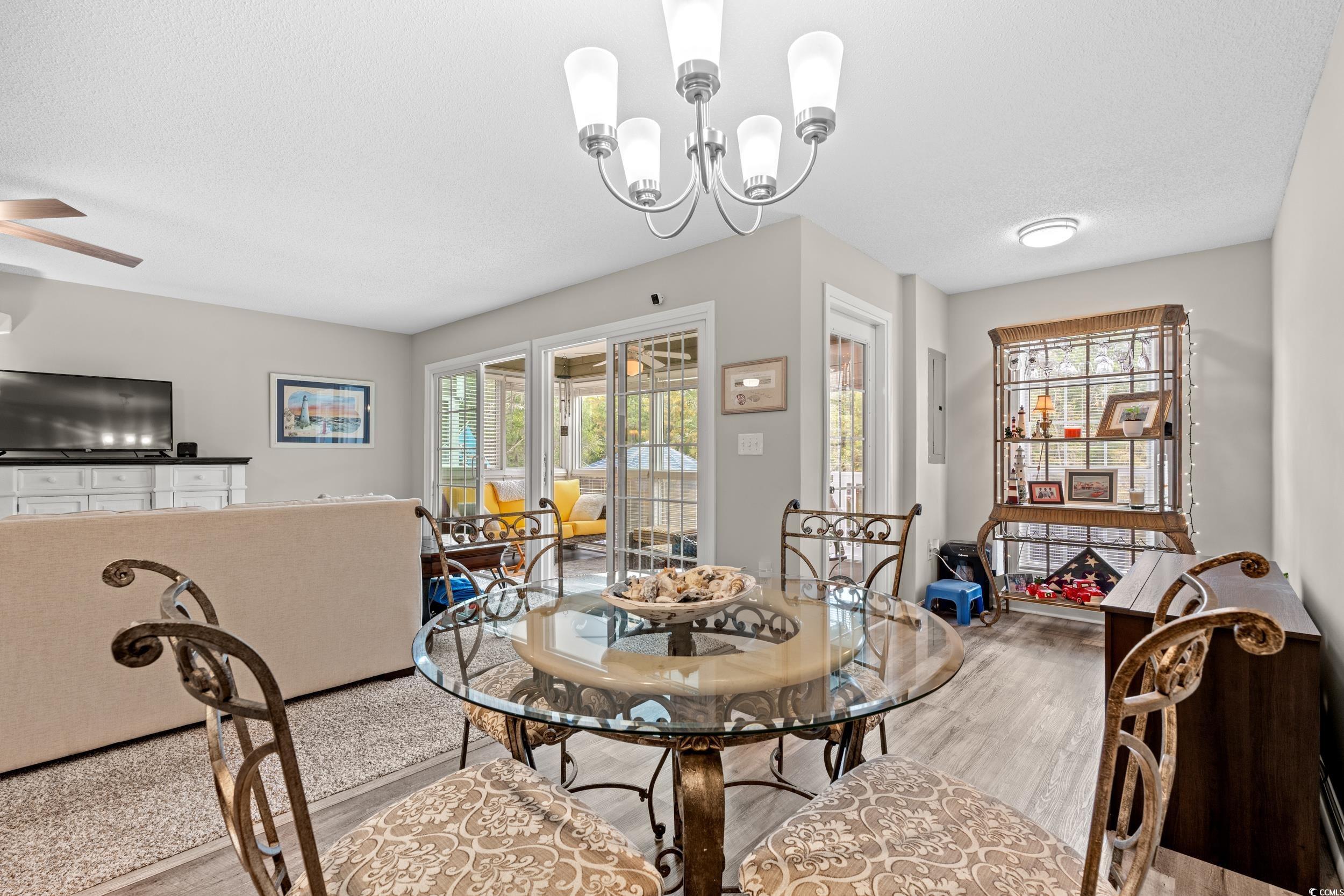 14 Laurel Street, Unit 14 Conway, SC 29526 - Photo 9 of 40 Dining space featuring wood finished floors, a textured ceiling, a chandelier, and ceiling fan