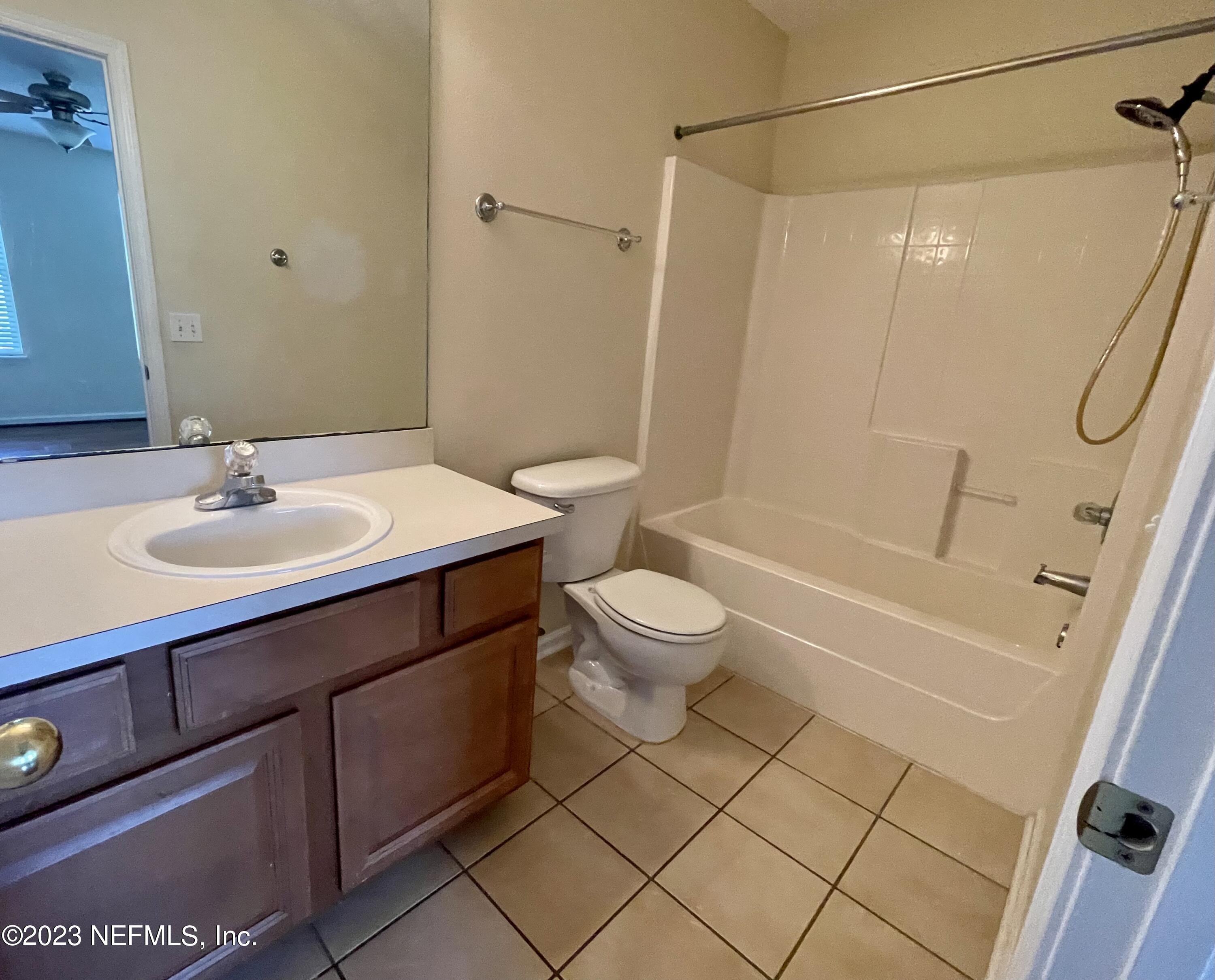 938 Scrub Jay Drive St. Augustine, FL 32092 - Photo 11 of 13 a bathroom with a sink toilet and shower