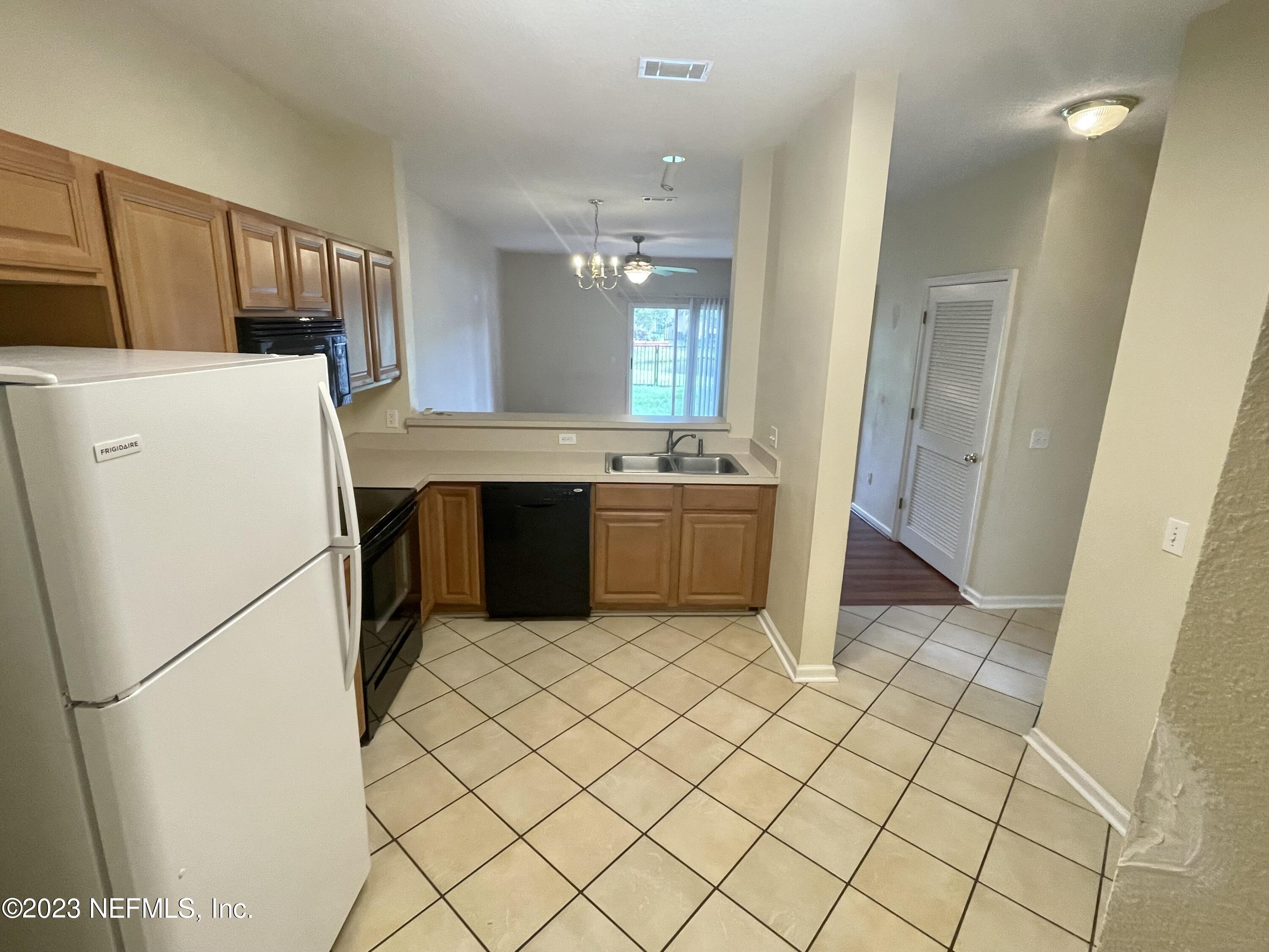 938 Scrub Jay Drive St. Augustine, FL 32092 - Photo 3 of 13 a kitchen with a refrigerator sink washer and dryer