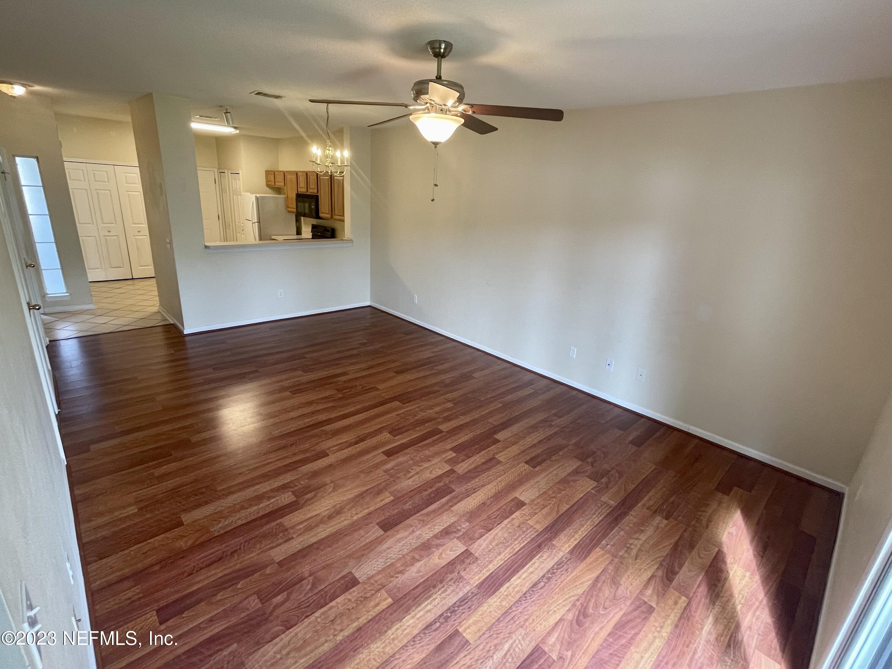 938 Scrub Jay Drive St. Augustine, FL 32092 - Photo 4 of 13 wooden floor in an empty room with a window