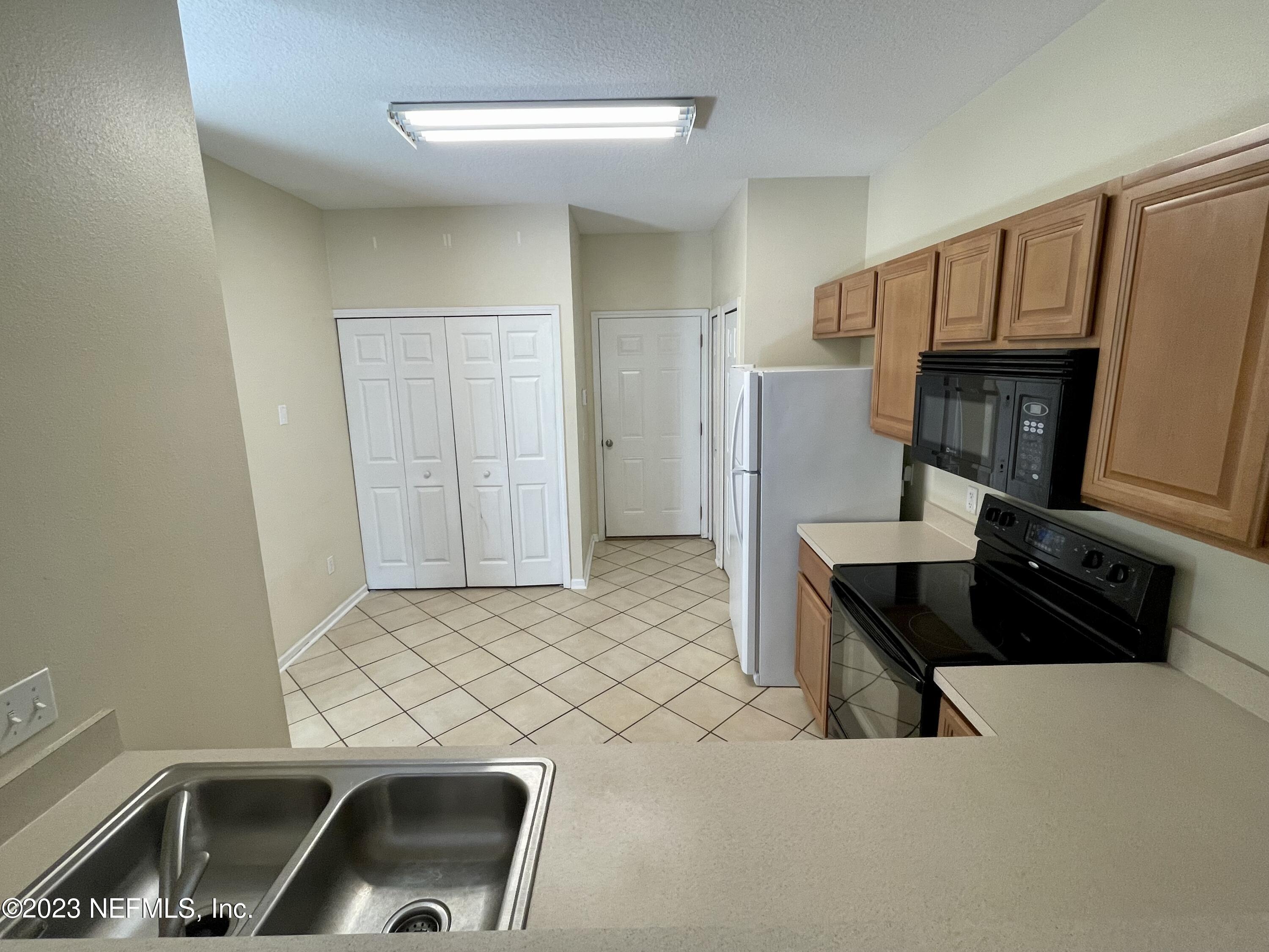 938 Scrub Jay Drive St. Augustine, FL 32092 - Photo 6 of 13 a living room with a couch and a table with wooden floor