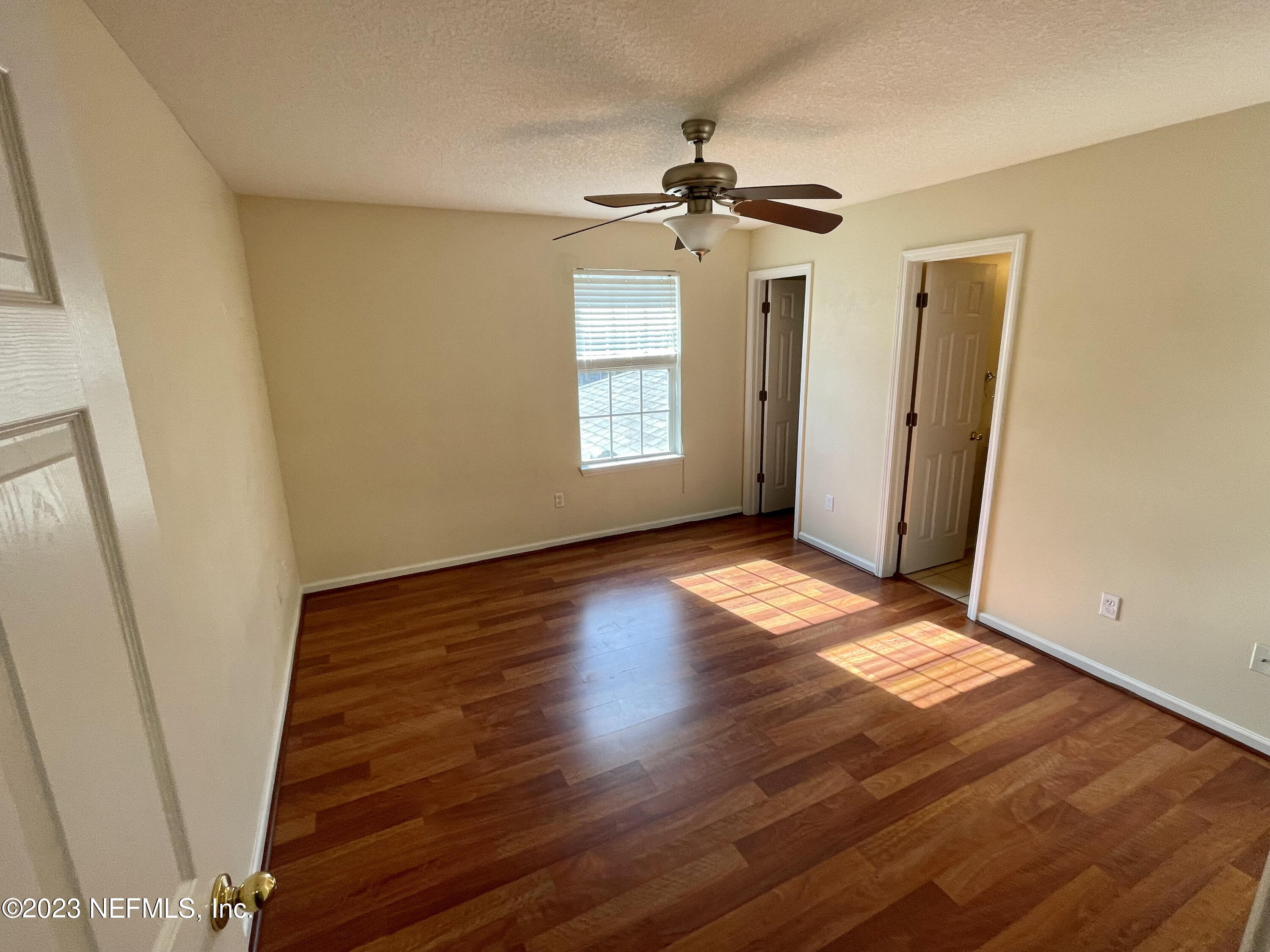 938 Scrub Jay Drive St. Augustine, FL 32092 - Photo 9 of 13 a view of an empty room with wooden floor and a window