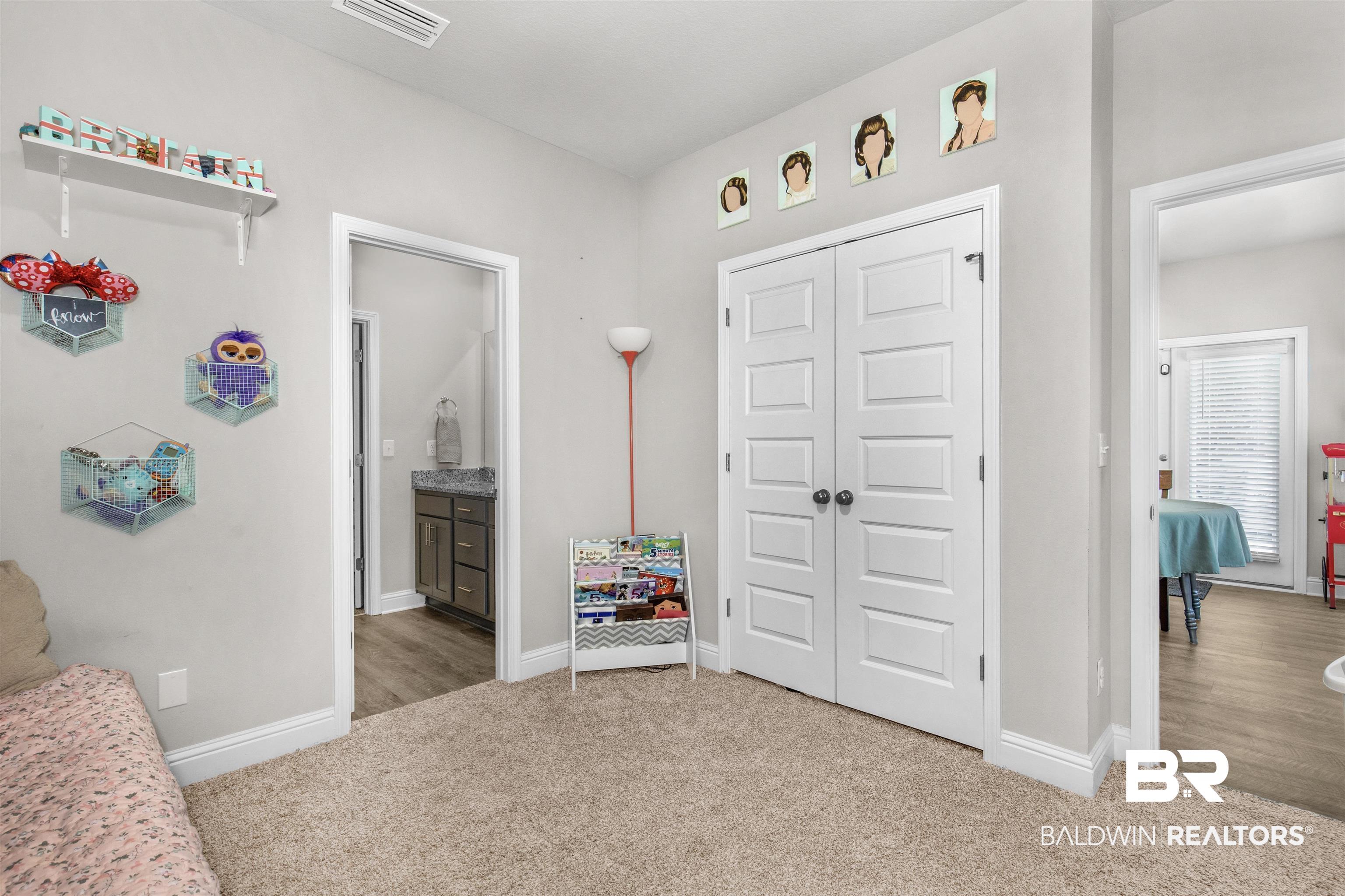 2345 Laurel Street Semmes, AL 36575 - Photo 19 of 31 Bedroom featuring carpet floors, a closet, and connected bathroom