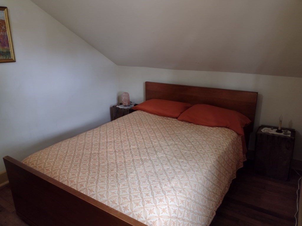 3 York Road Colrain, MA 01340 - Photo 27 of 37 a bed sitting in a bedroom next to a lamp