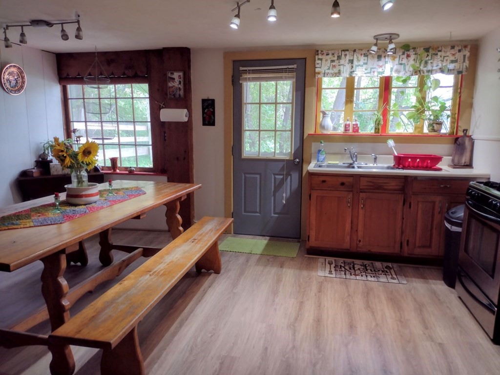 3 York Road Colrain, MA 01340 - Photo 8 of 37 a large kitchen with kitchen island a large window a sink and stainless steel appliances