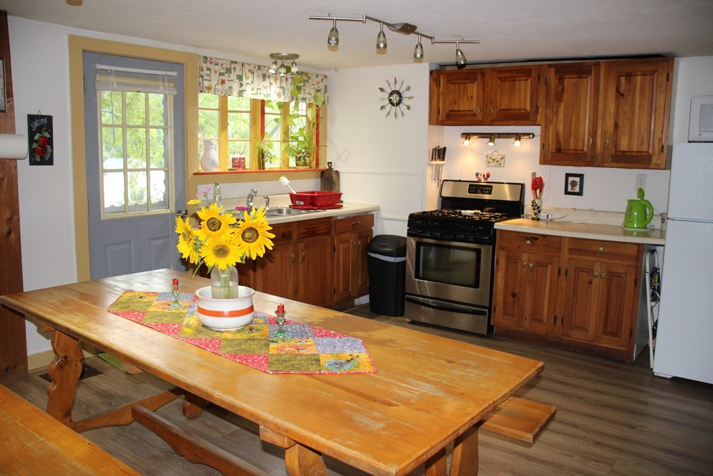 3 York Road Colrain, MA 01340 - Photo 10 of 37 a kitchen with stainless steel appliances wooden floor dining table and chairs