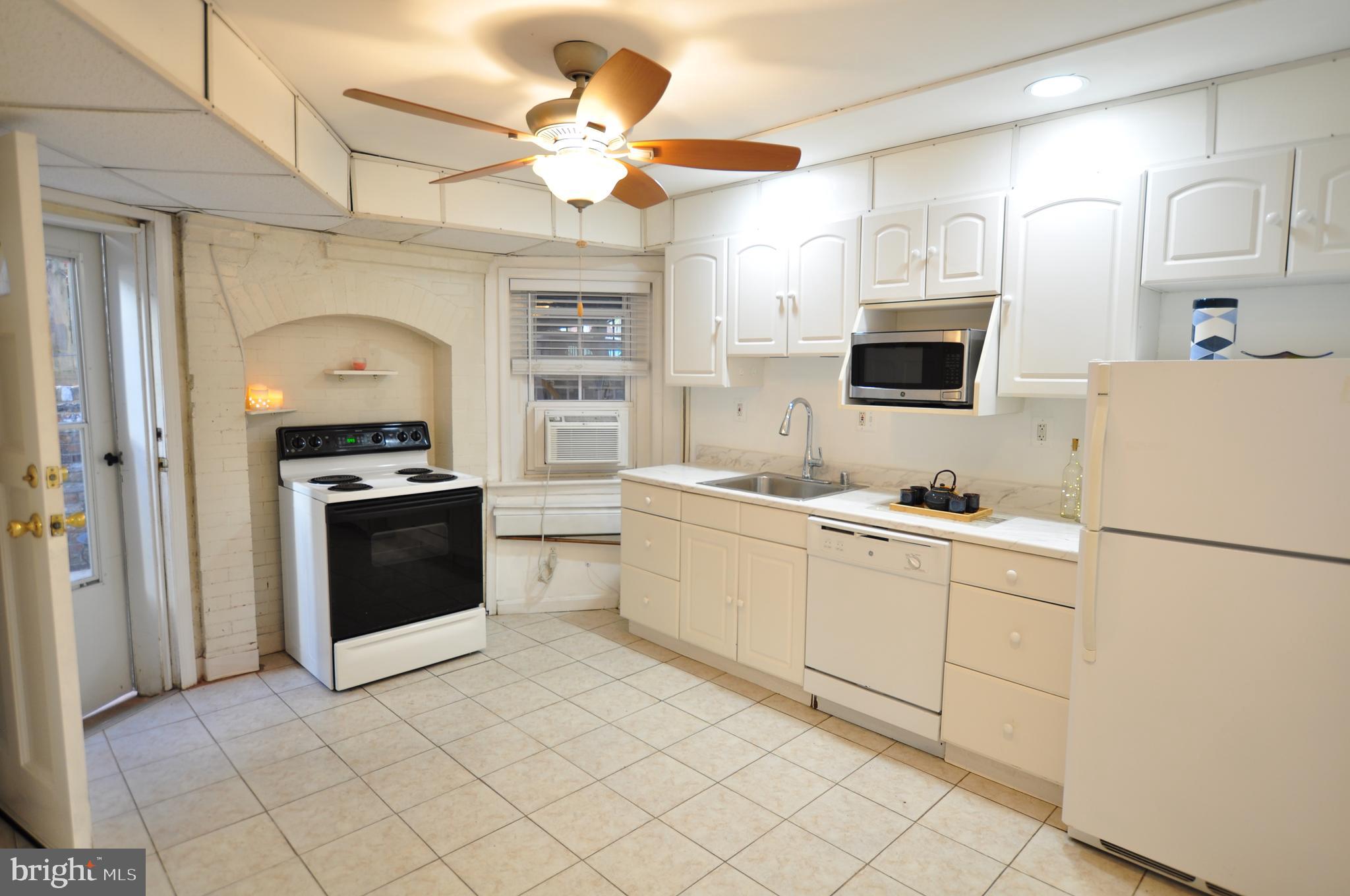 1904 Calvert Street Northwest Washington, DC 20009 - Photo 6 of 13 a kitchen with a sink appliances and cabinets