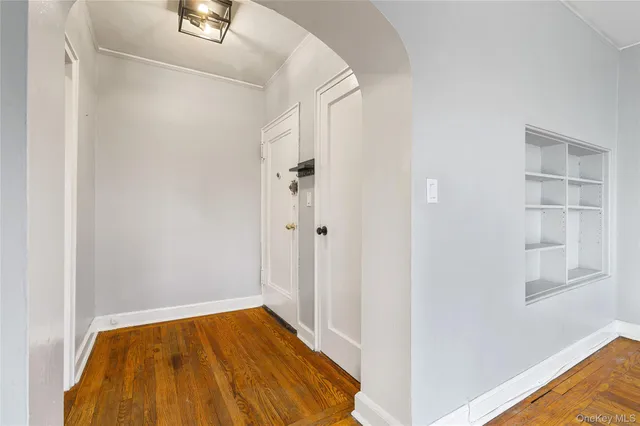 a view of a bedroom with wooden floor and closet