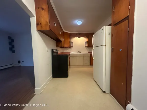 a kitchen with refrigerator and cabinets